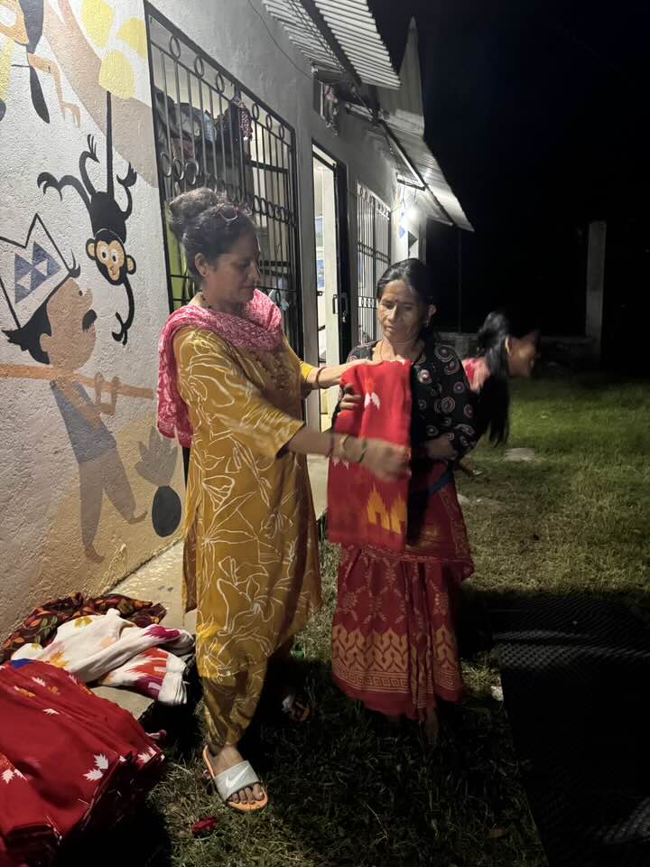 Distributing sarees to women in Saldum village through Nagarjun Learning Center